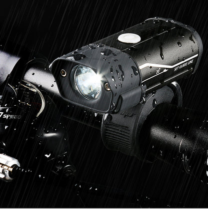 Bicycle light on a bike handlebar with raindrops, brand 'Speed' visible